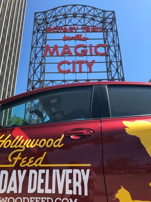 Hollywood Feed Staff posing with the Same Day Delivery Car